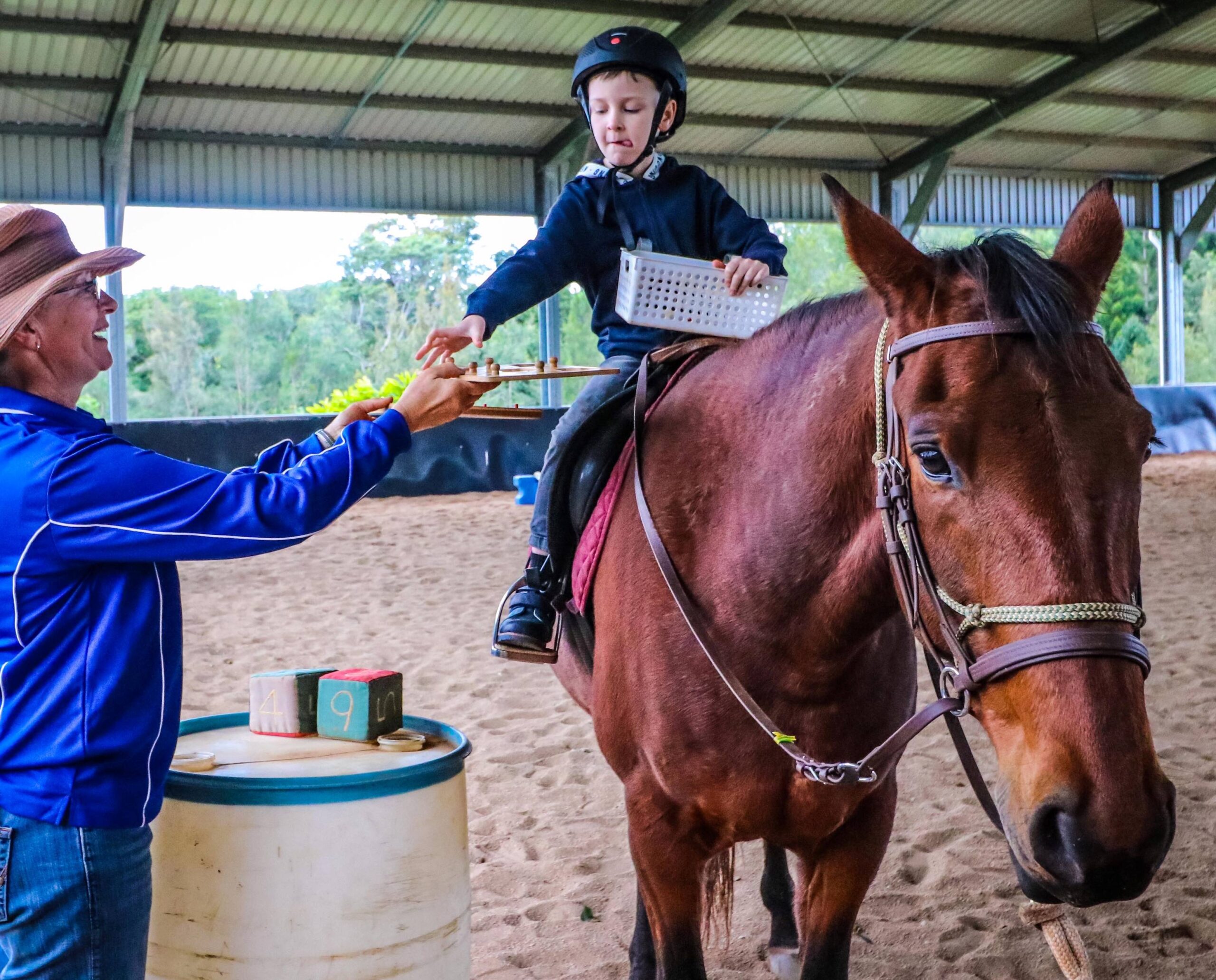 Young boy with disability riding horse and learning life skills